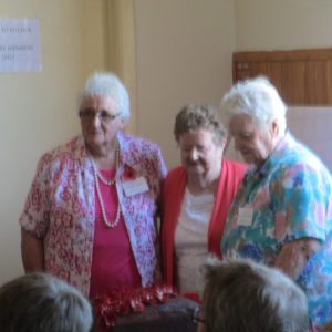 Shirley (Delaney), Noelene (O'Brien), & Alice (Murray) cut the Remembrance cake The Gathering Place 18 Oct 2015